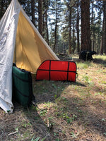 canvas tent with bow cases and bear archery target